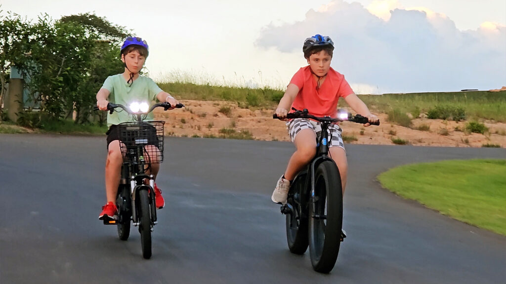 Young boys riding e-bikes.