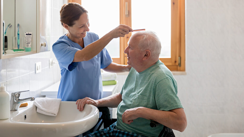 A nurse caring for an older man.