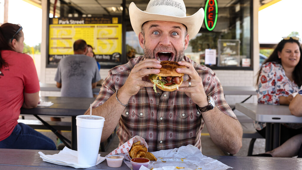 Chet Garner eating a burger.