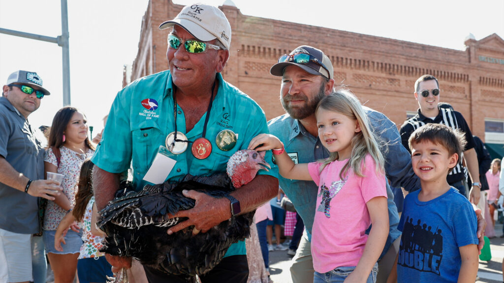 Person holding a turkey.