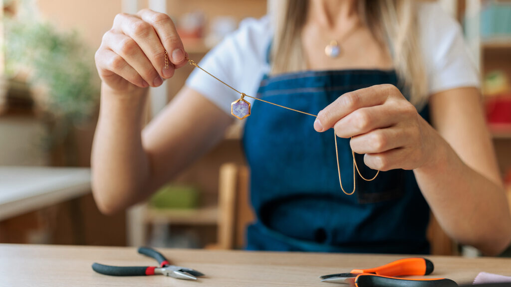 Person making jewelry.